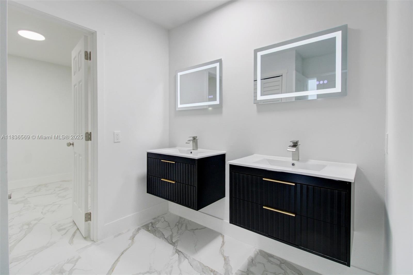 4808 Mango Drive Tamarac, FL 33319 - Photo 13 of 36 a spacious bathroom with a sink double vanity and a mirror