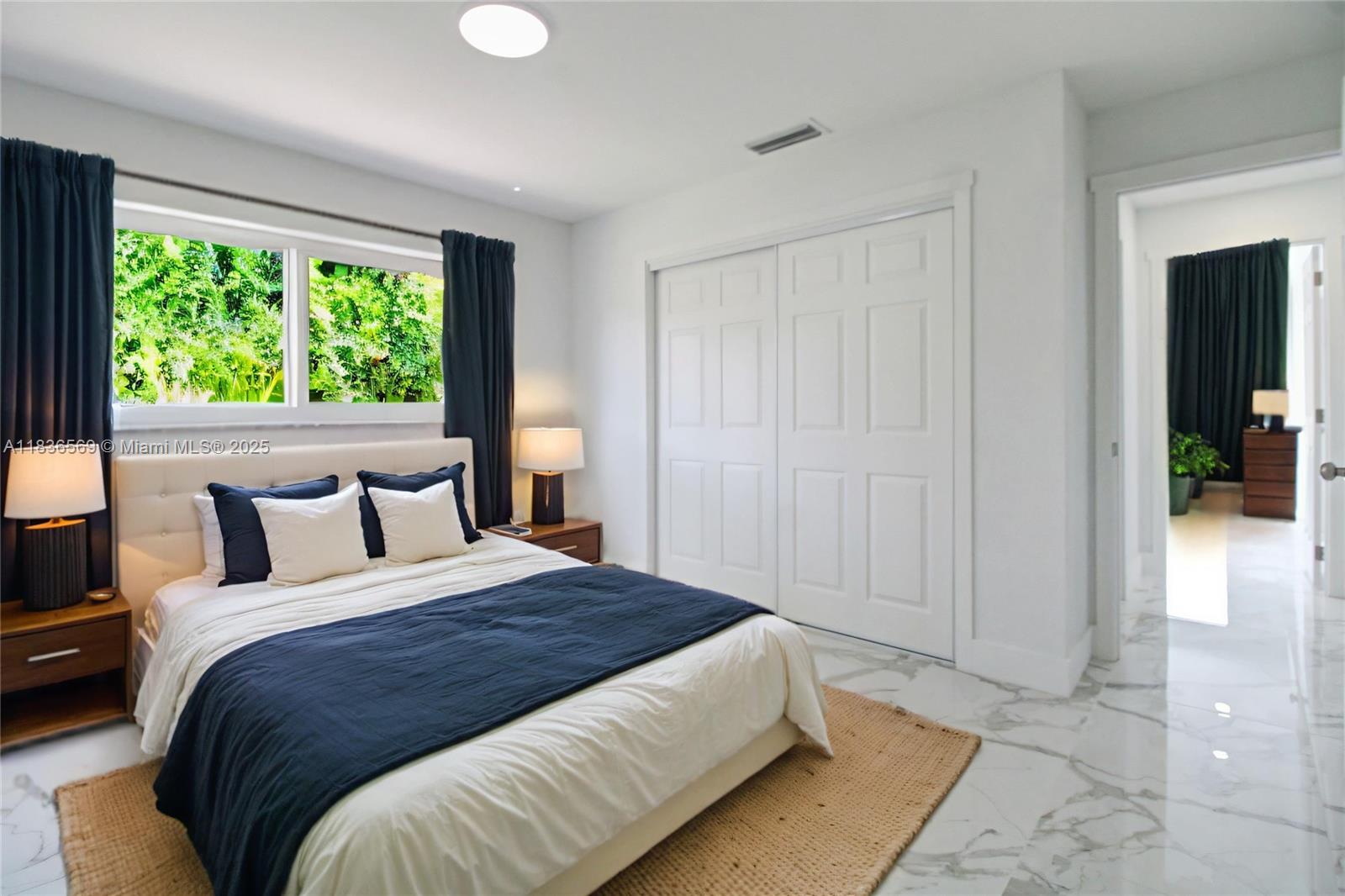 4808 Mango Drive Tamarac, FL 33319 - Photo 16 of 36 a bedroom with a bed and a large window