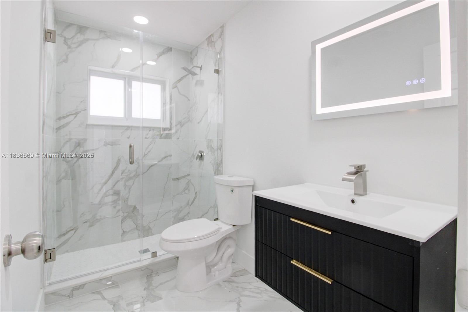 4808 Mango Drive Tamarac, FL 33319 - Photo 17 of 36 a bathroom with a sink a toilet and shower