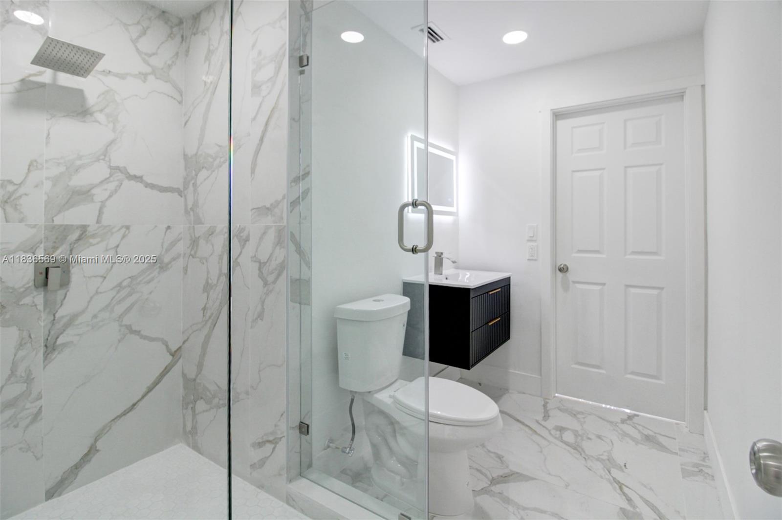 4808 Mango Drive Tamarac, FL 33319 - Photo 20 of 36 a bathroom with a toilet and a shower