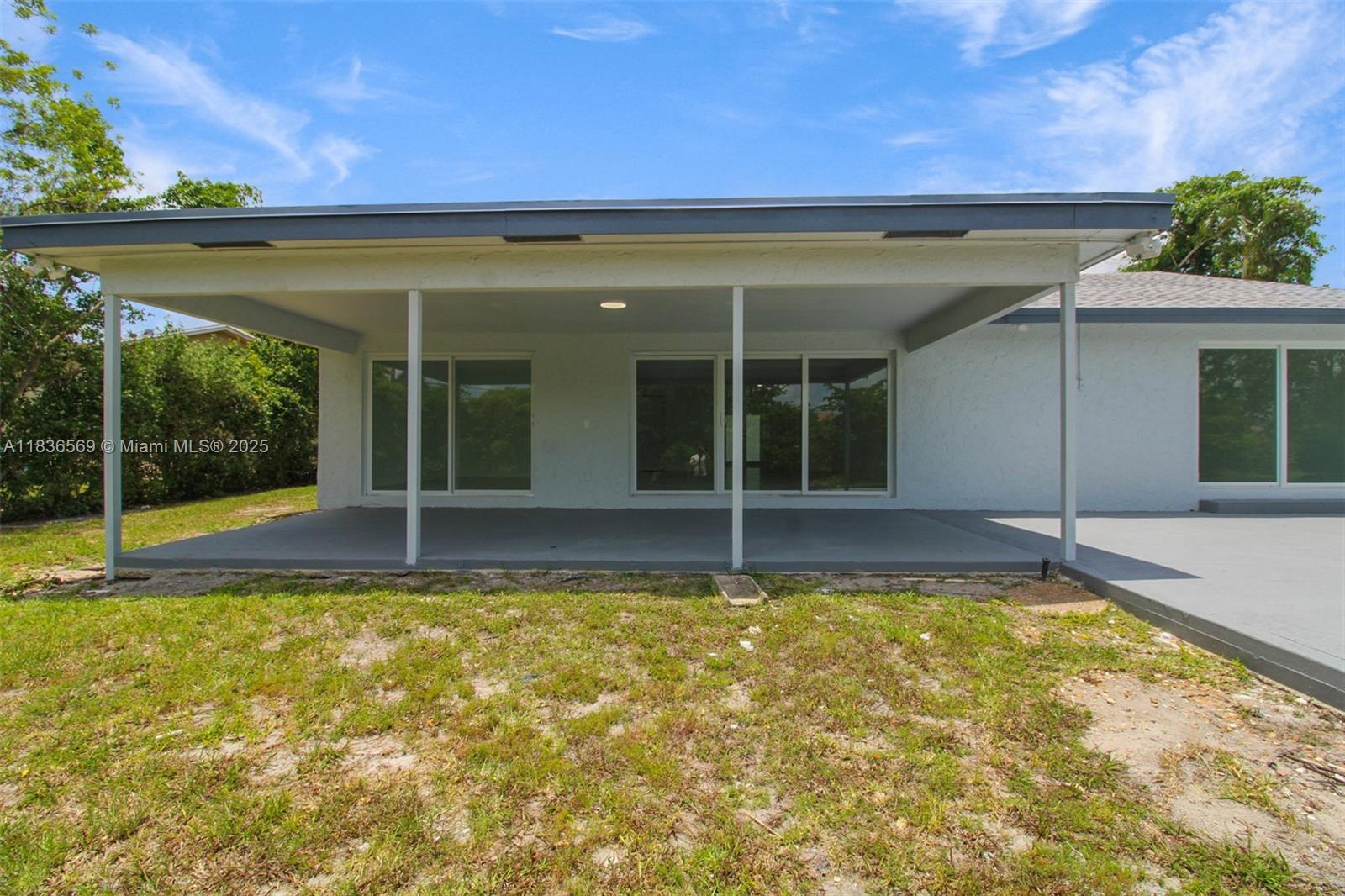 4808 Mango Drive Tamarac, FL 33319 - Photo 33 of 36 a view of pool with lawn chairs and plants