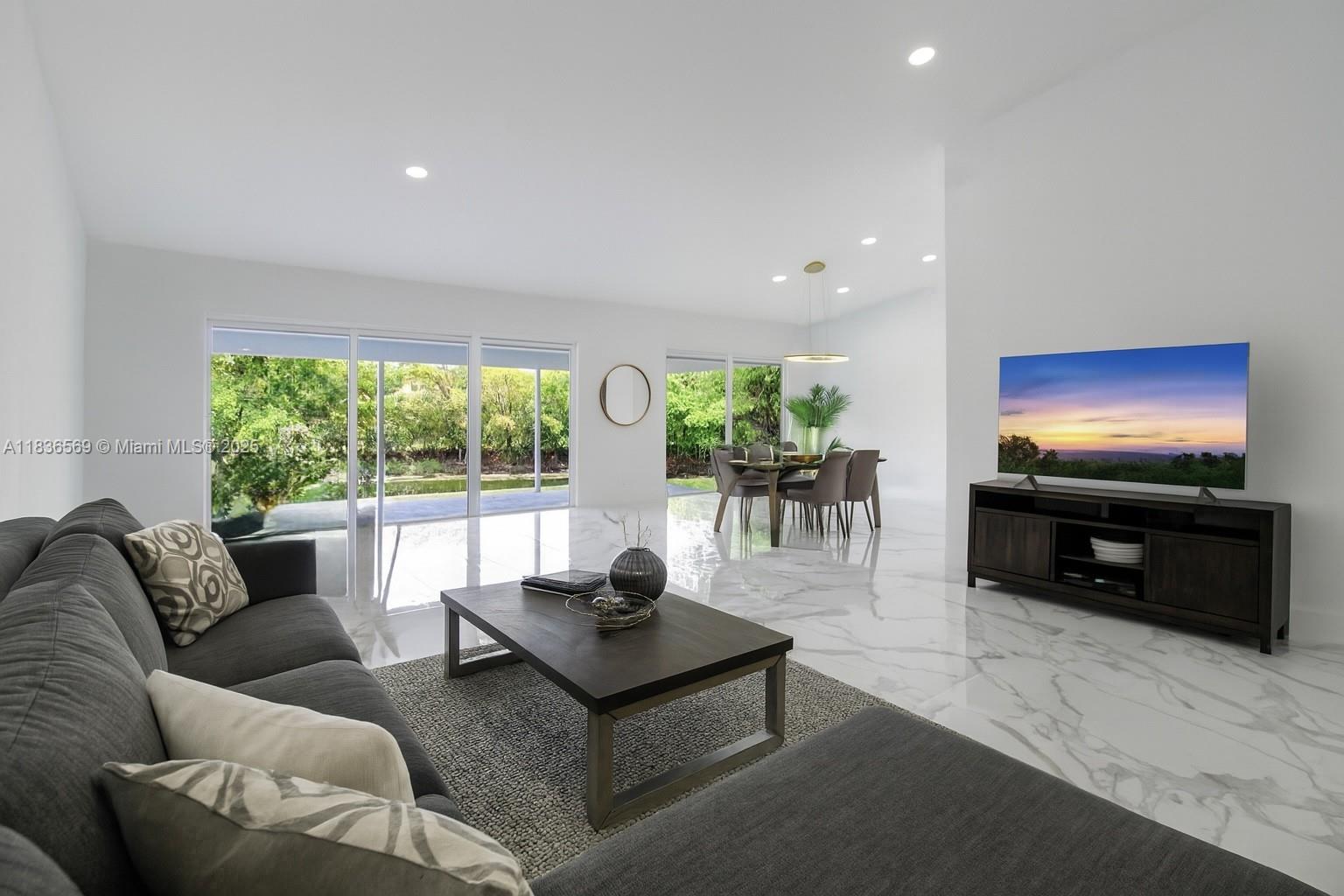 4808 Mango Drive Tamarac, FL 33319 - Photo 6 of 36 a living room with furniture and a flat screen tv