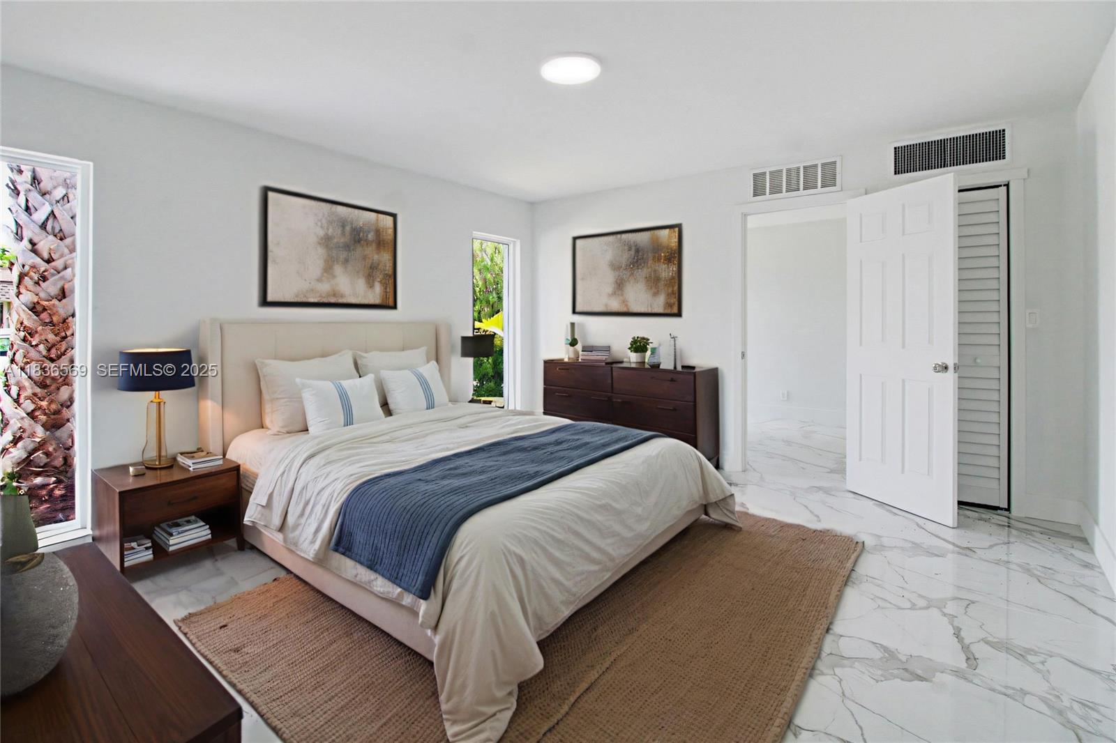 4808 Mango Drive Tamarac, FL 33319 - Photo 9 of 36 a bedroom with a bed and a painting on the wall