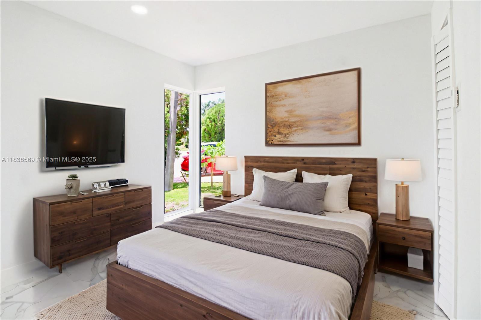 4808 Mango Drive Tamarac, FL 33319 - Photo 10 of 36 a bedroom with a bed and a flat screen tv