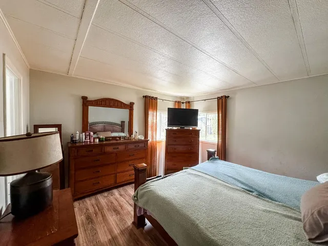 a bedroom with a bed and a flat screen tv