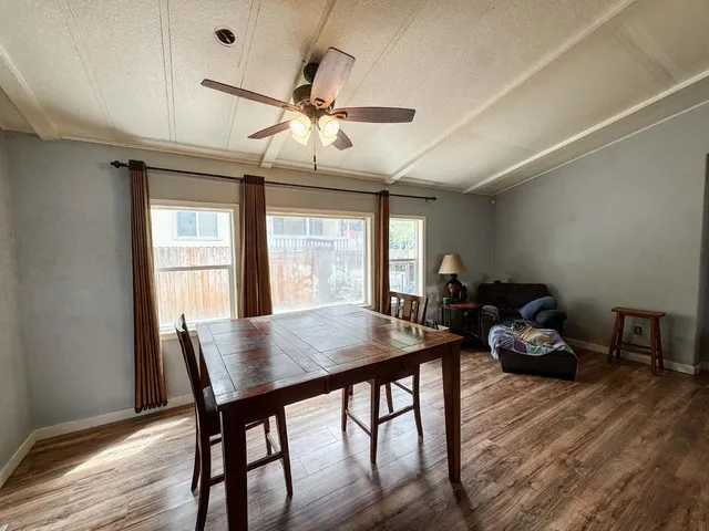 a room with a table chairs and wooden floor