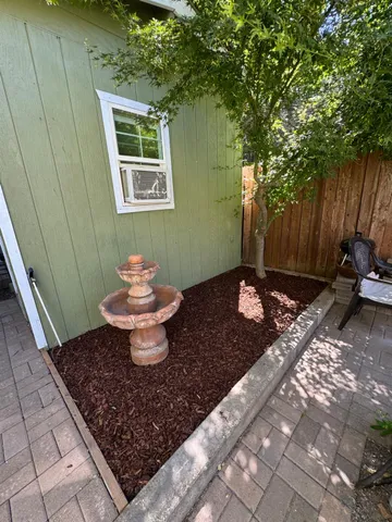 a view of a backyard with table and chairs and potted plants