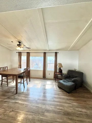 a living room with furniture and a wooden floor