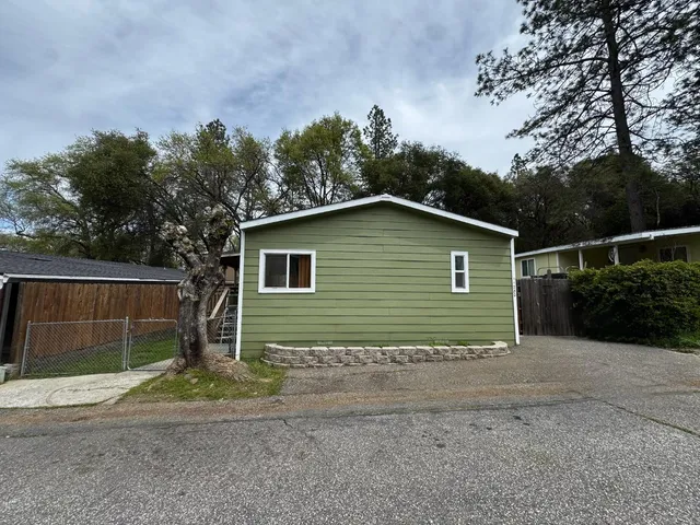 a view of a house with a yard and garage