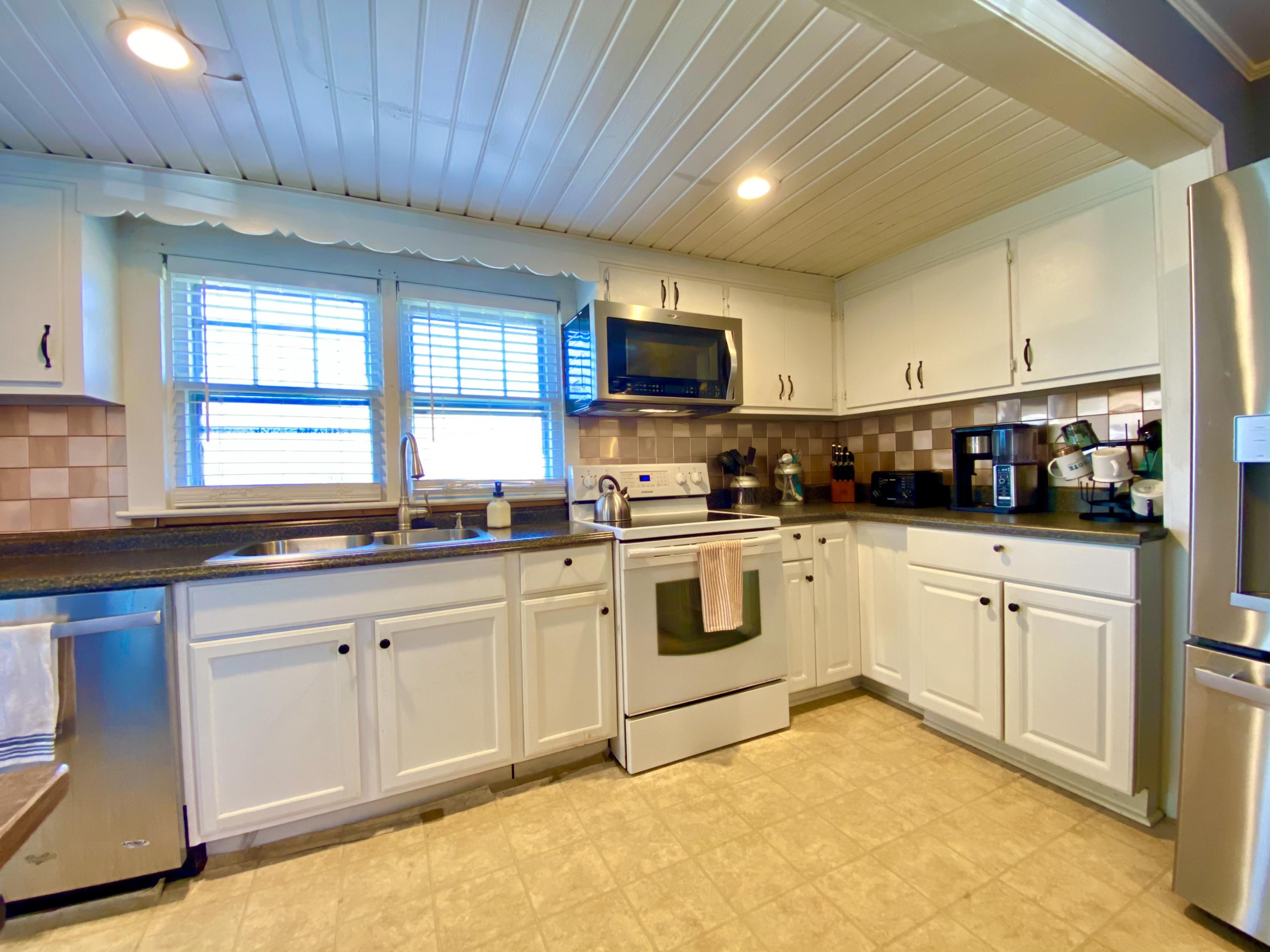 1121 Stone Mill Road Hurt, VA 24563 - Photo 13 of 28 a kitchen with granite countertop a sink window and cabinets