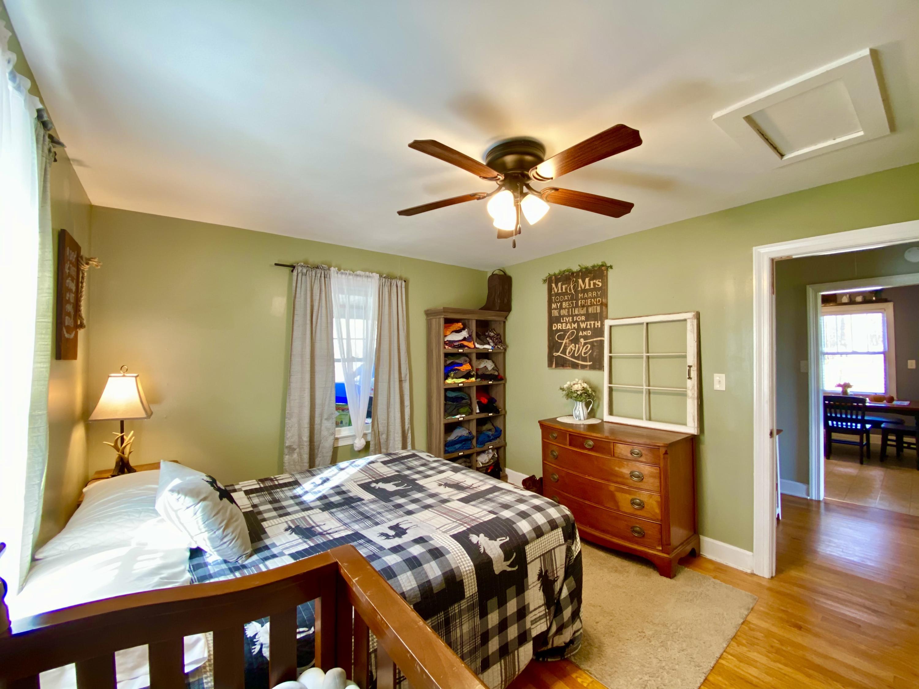 1121 Stone Mill Road Hurt, VA 24563 - Photo 23 of 28 a bedroom with a bed a dresser and wooden floor