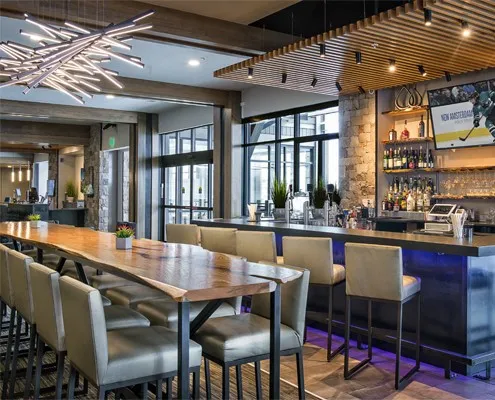 a dining hall with stainless steel appliances granite countertop a dining table and chairs