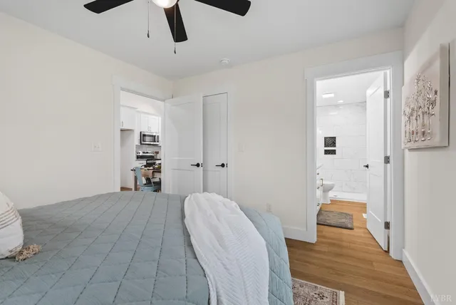 a view of a room with wooden floor and white walls