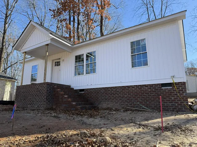 a front view of a house with plants