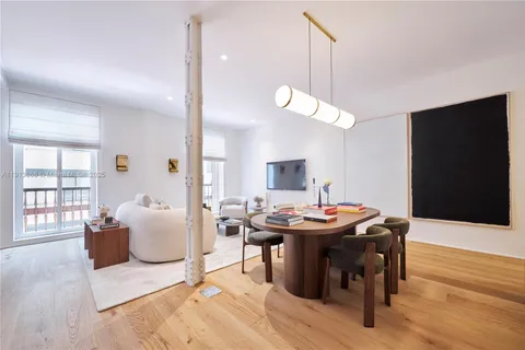 a dining room with furniture and wooden floor