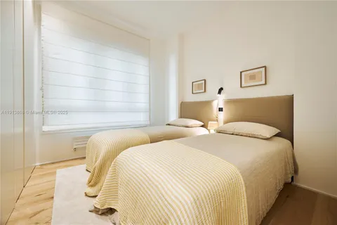 a bedroom with double bed and a window