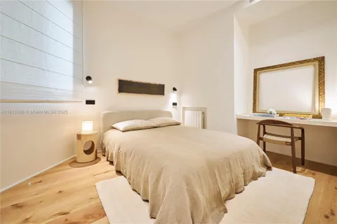 a bedroom with a bed and a desk