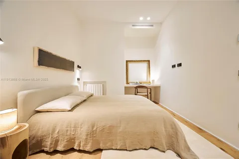 a bedroom with a bed and a tv