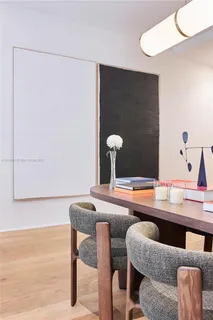 a dining room with table chairs and wooden floor