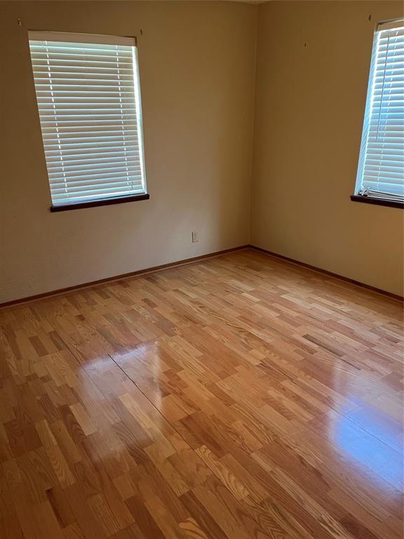 2190 West Fm 574 Road West Mullin, TX 76864 - Photo 34 of 40 a view of an empty room with wooden floor and a window