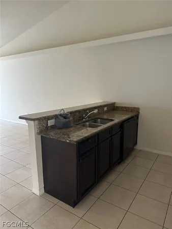 a kitchen with granite countertop a sink and a stove