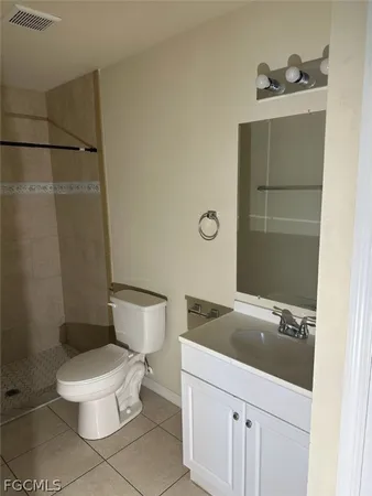a bathroom with a sink and mirror with toilet