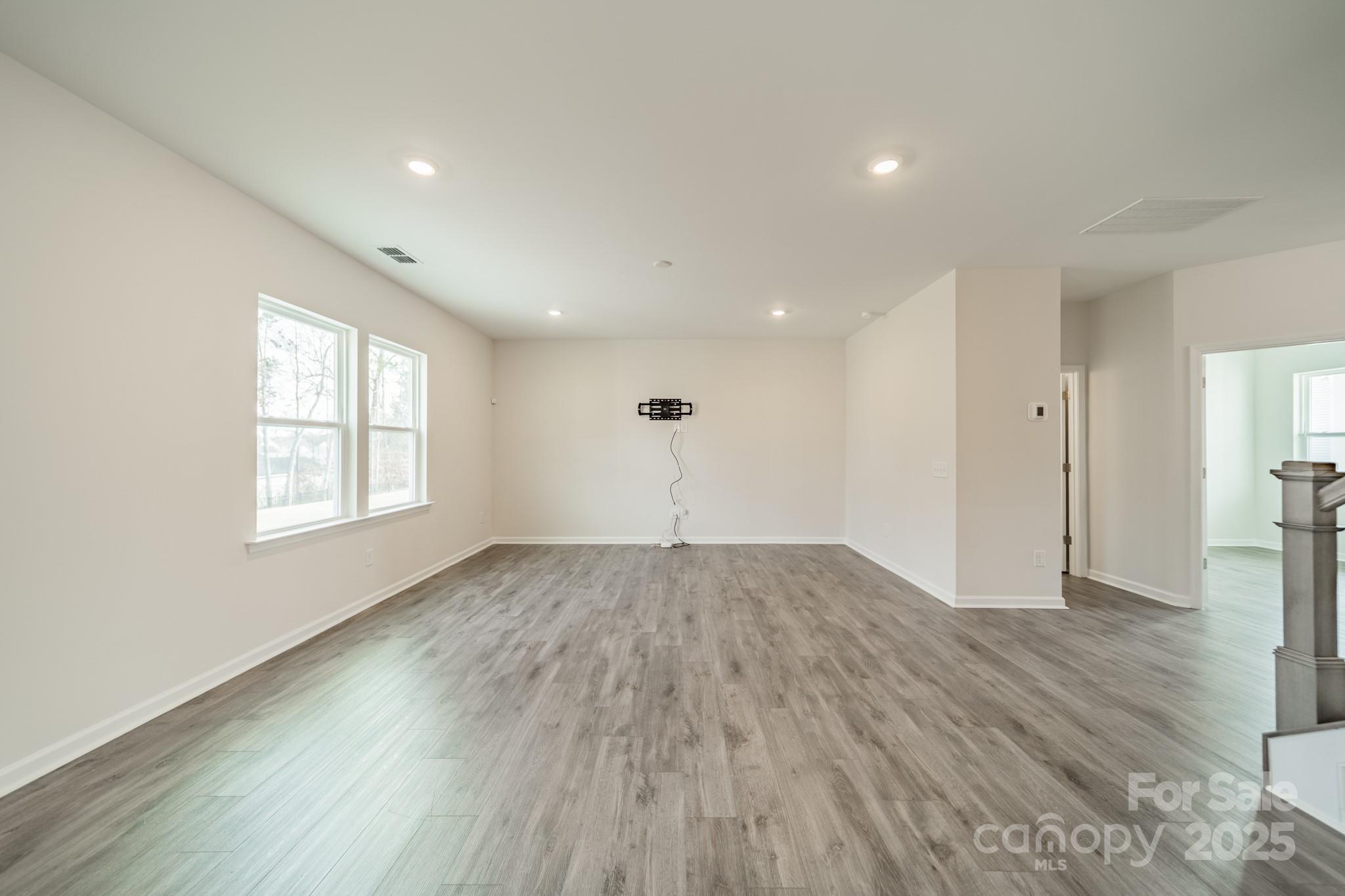 6012 Chumbley Pt Road Charlotte, NC 28215 - Photo 12 of 46 a view of empty room with wooden floor and fan