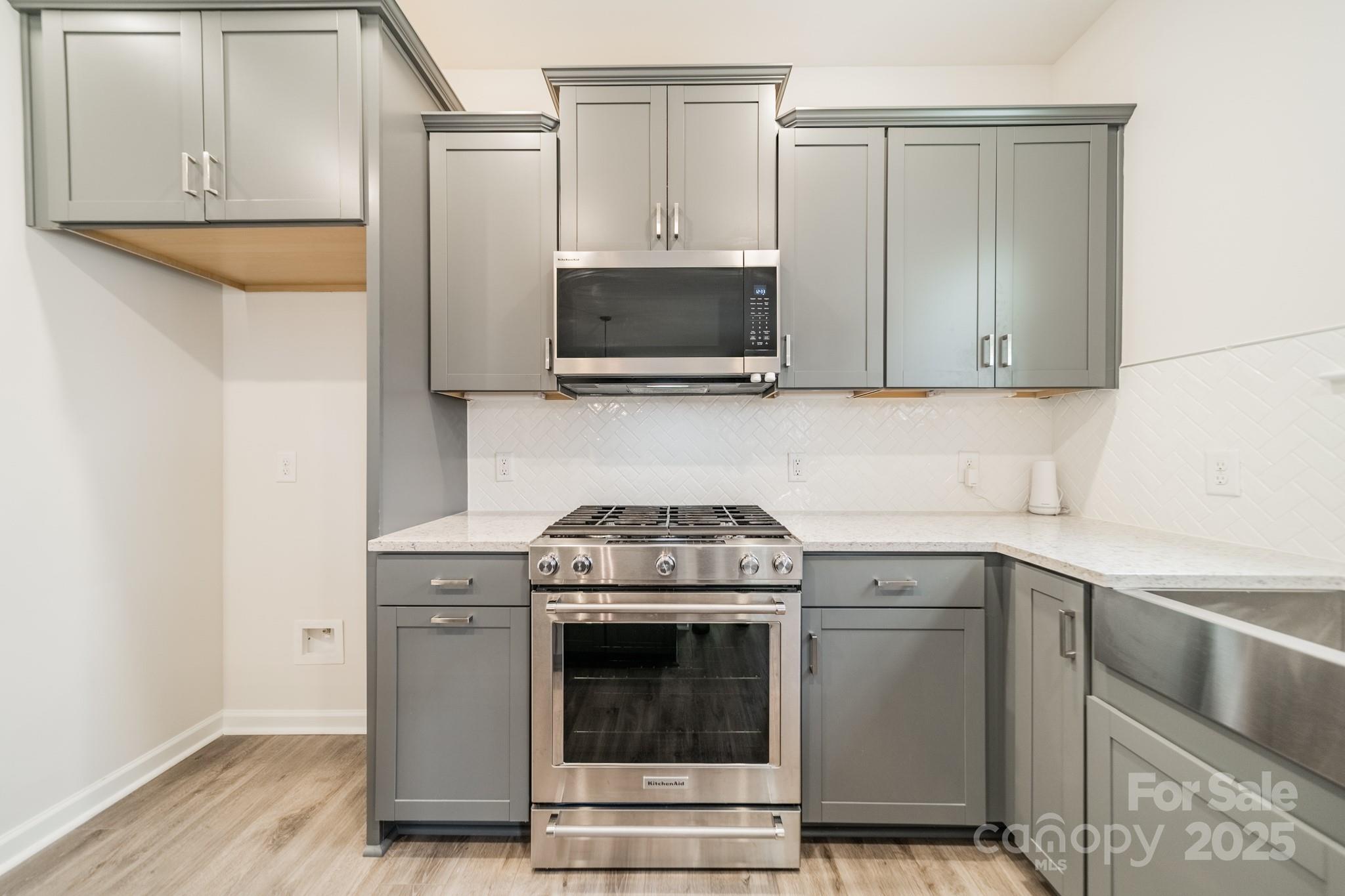 6012 Chumbley Pt Road Charlotte, NC 28215 - Photo 16 of 46 a kitchen with a stove and a microwave