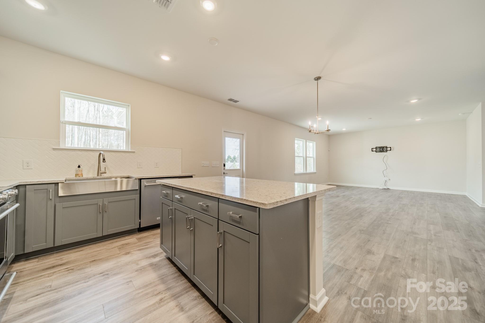 6012 Chumbley Pt Road Charlotte, NC 28215 - Photo 18 of 46 a kitchen with granite countertop a sink and cabinets