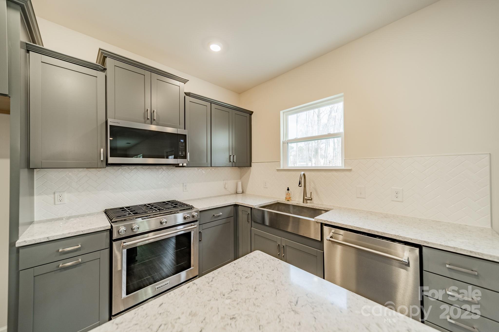 6012 Chumbley Pt Road Charlotte, NC 28215 - Photo 19 of 46 a kitchen with a sink stove and microwave