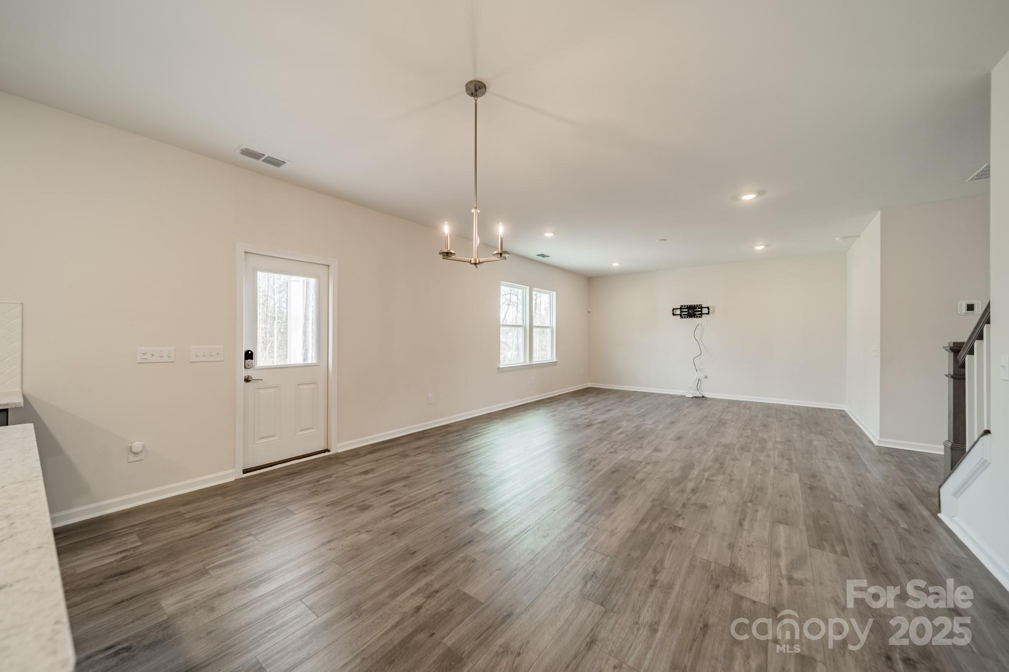 6012 Chumbley Pt Road Charlotte, NC 28215 - Photo 20 of 46 a view of a room with wooden floor and window