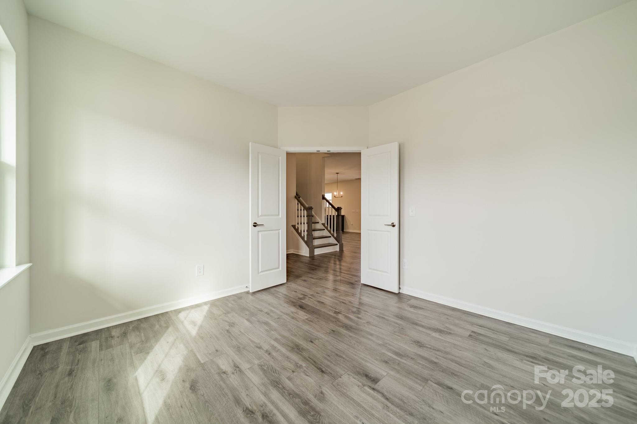 6012 Chumbley Pt Road Charlotte, NC 28215 - Photo 7 of 46 a view of a hallway with wooden floor and a refrigerator
