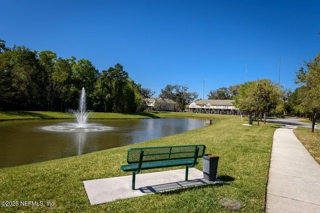 a view of a lake with a bench in the background