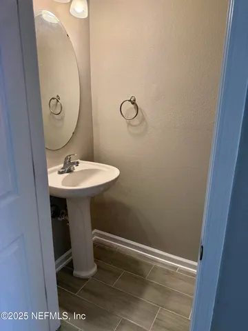 a bathroom with a sink toilet and mirror