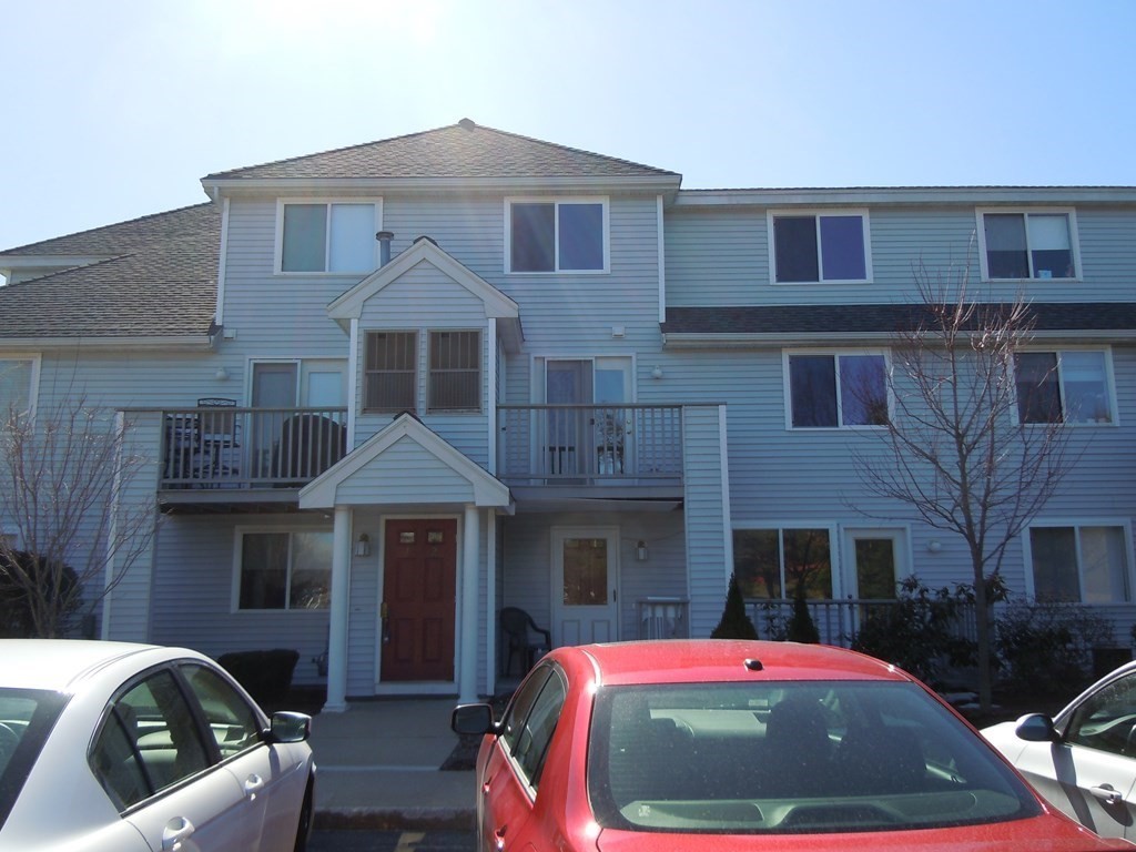 360 Littleton Road, Unit B2 Chelmsford, MA 01824 - Photo 3 of 10 a front view of a house with a yard