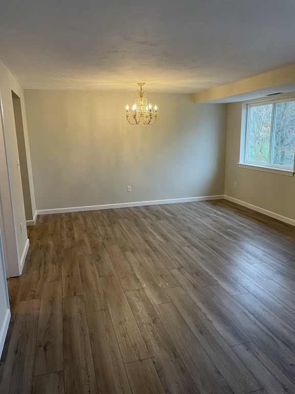 360 Littleton Road, Unit B2 Chelmsford, MA 01824 - Photo 5 of 10 a view of empty room with wooden floor and fan