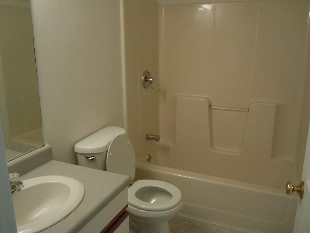 360 Littleton Road, Unit B2 Chelmsford, MA 01824 - Photo 10 of 10 a bathroom with a sink a toilet and shower
