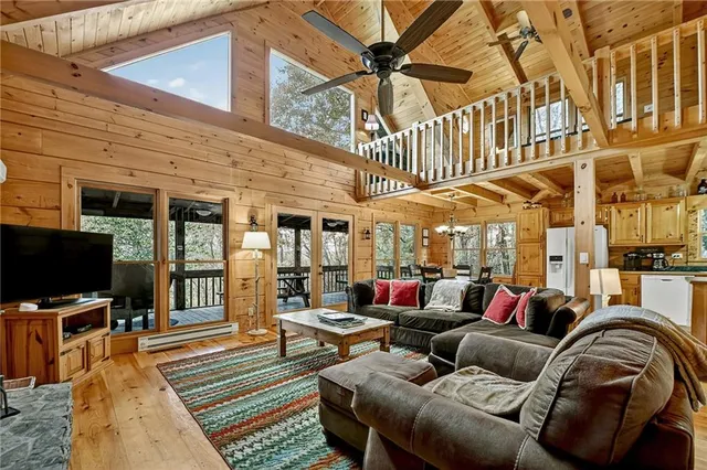 a outdoor living space with patio furniture and a flat screen tv