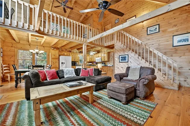 a living room with furniture a rug and a chandelier