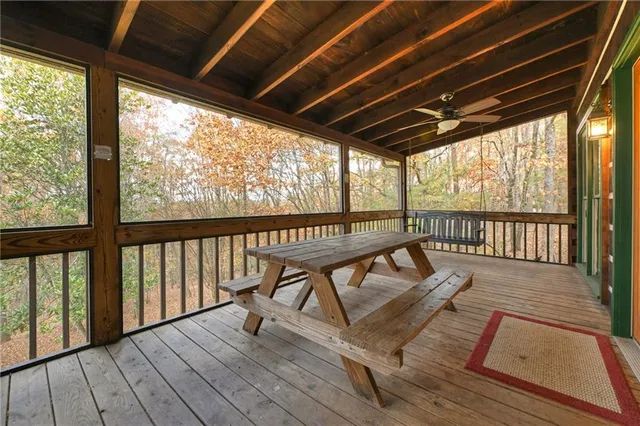 a roof deck with wooden floor and outdoor seating
