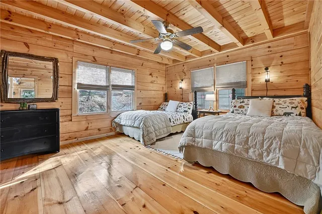 a large bed sitting in a bedroom next to a window