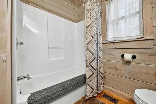 a bathroom with a bathtub and shower