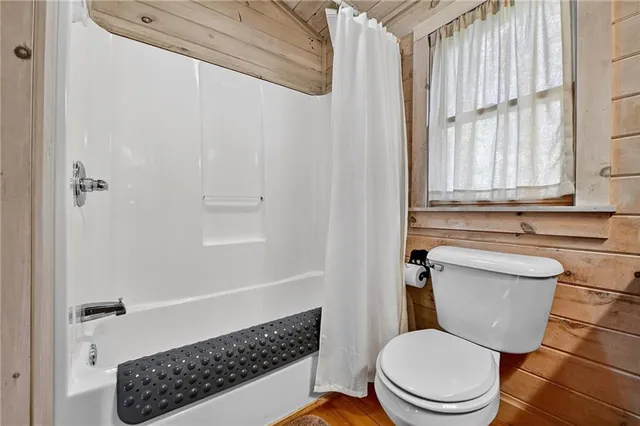 a bathroom with a toilet a sink and a window