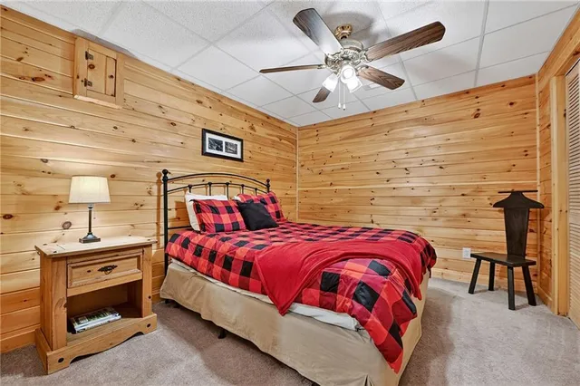 a bedroom with a bed and a ceiling fan