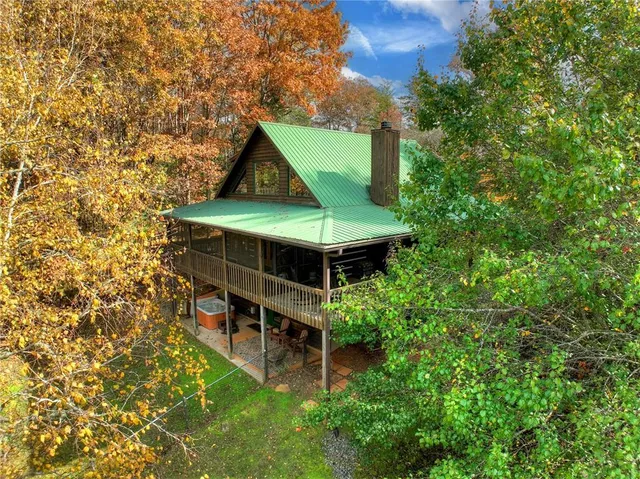an aerial view of a house with swimming pool and big yard