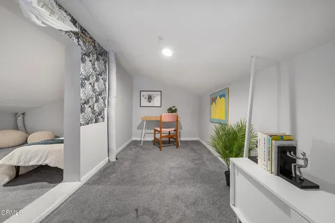 a view of a livingroom with furniture and staircase