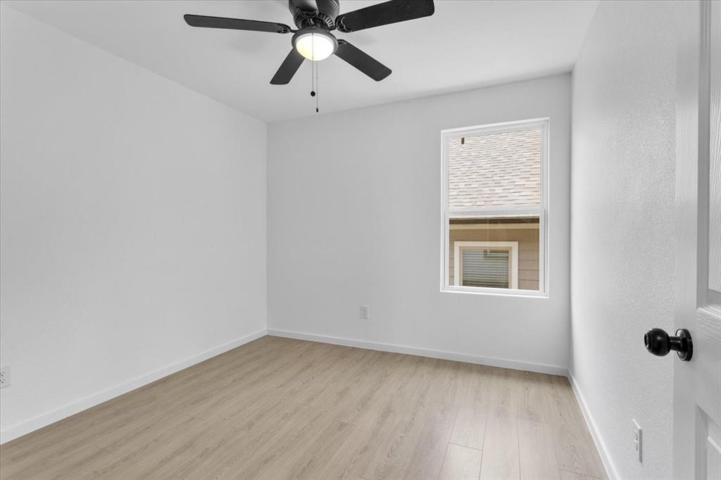 415 East Monterey Street Denison, TX 75021 - Photo 13 of 23 an empty room with a window and a fan