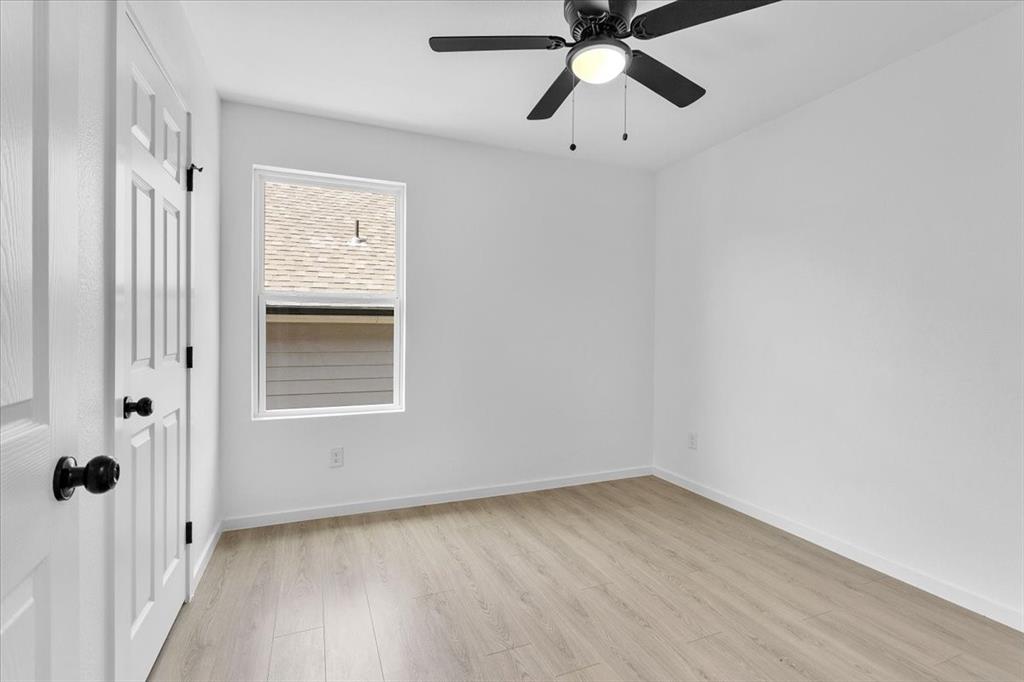 415 East Monterey Street Denison, TX 75021 - Photo 22 of 23 an empty room with a window and a fan