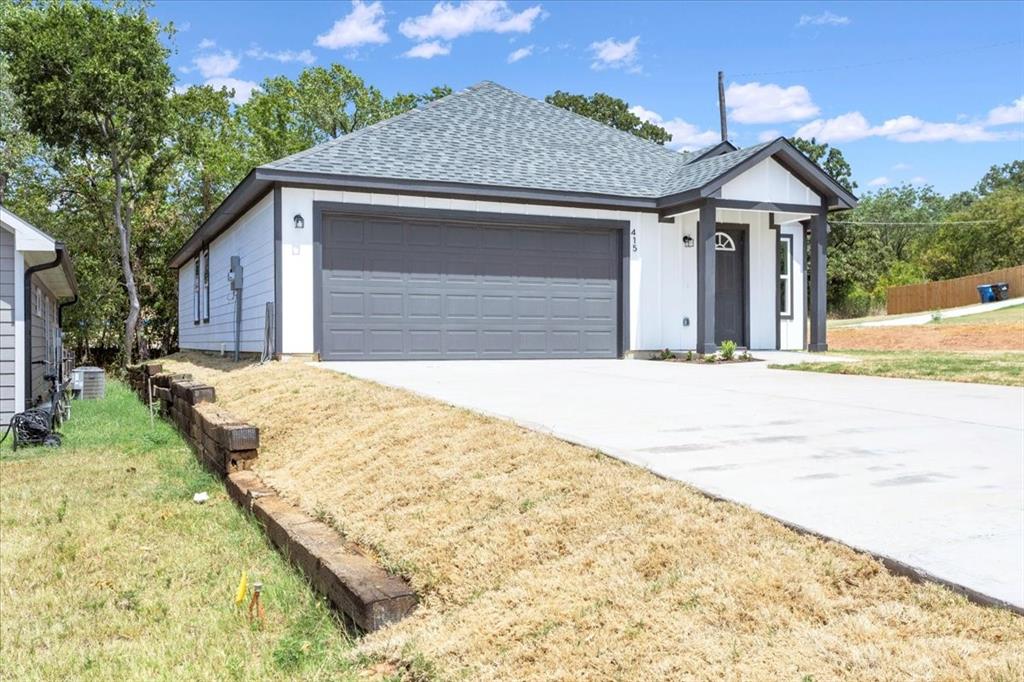415 East Monterey Street Denison, TX 75021 - Photo 3 of 23 a front view of a house with a yard and garage