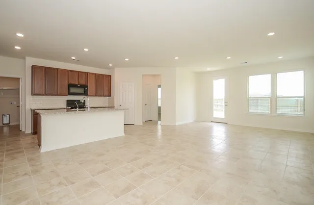 a kitchen with stainless steel appliances granite countertop a sink stove and cabinets